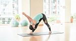 Asian Woman Doing Yoga Indoors Stock Photo