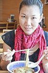 Asian Woman Is Eating Noodles Stock Photo