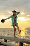 Asian Woman Relaxing Summer Vacation At Sea Beach Against Beautiful Sun Set Sky Stock Photo