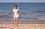 Asian Woman Walking On Beach Stock Photo