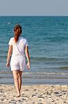 Asian Woman Walking On Beach Stock Photo