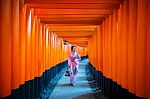 Asian Women In Traditional Japanese Kimonos At Fushimi Inari Shrine In Kyoto, Japan Stock Photo