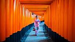 Asian Women In Traditional Japanese Kimonos At Fushimi Inari Shrine In Kyoto, Japan Stock Photo