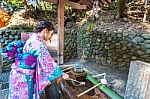 Asian Women In Traditional Japanese Kimonos At Fushimi Inari Shrine In Kyoto, Japan Stock Photo