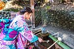 Asian Women In Traditional Japanese Kimonos At Fushimi Inari Shrine In Kyoto, Japan Stock Photo