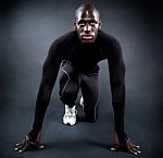 Athletic Man Running In Black Background Stock Photo