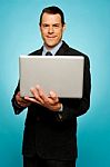 Attractive Businessman Holding Laptop Stock Photo