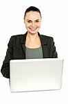 Attractive Corporate Female Working On Laptop Stock Photo