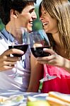 Attractive Couple Drinking Wine On Romantic Picnic In Countrysid Stock Photo