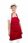 Attractive Female Chef Wearing Red Apron And Hat Stock Photo