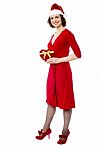 Attractive Lady In Red Attire With Xmas Gift Stock Photo