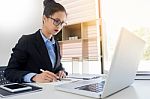 Attractive Women In Casual Business Sitting At A Table Working O Stock Photo