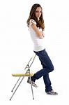 Attractive Young Female Standing With Support Of Chair Stock Photo