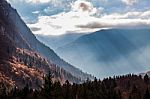 Autumn Valley In The Alps With Sunlight Breaking Through Stock Photo