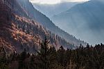 Autumn Valley In The Alps With Sunlight Breaking Through Stock Photo