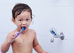 Baby And Toothbrush Stock Photo