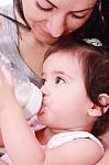 Baby Drinking Milk From Bottle Stock Photo