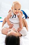 Baby Girl And Her Mother Playing At Home Stock Photo