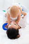 Baby Girl And Her Mother Playing At Home Stock Photo