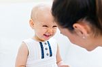 Baby Girl And Her Mother Playing At Home Stock Photo