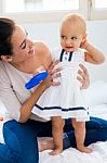 Baby Girl And Her Mother Playing At Home Stock Photo