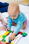 Baby Girl And Her Mother Playing At Home Stock Photo