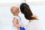 Baby Girl And Her Mother Playing At Home Stock Photo