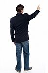 Back Pose Casual Guy Pointing At The Copy Space Area Stock Photo