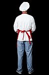 Back Pose Of A Male Chef In Uniform Stock Photo