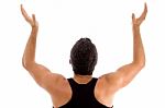 Back Pose Of Man With Raised Arms Stock Photo