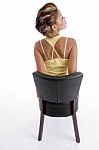 Back Pose Of Sitting Female Stock Photo