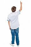 Back View Of Boy Shows Pointing Up Stock Photo