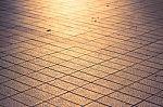 Background Texture Of Tile Roads And The Rays Of The Setting Sun Stock Photo