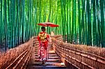 Bamboo Forest. Asian Woman Wearing Japanese Traditional Kimono At Bamboo Forest In Kyoto, Japan Stock Photo