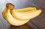 Banana On Brown Wooden Background Stock Photo