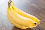 Banana On Brown Wooden Background Stock Photo