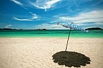 Beach Umbrella With Emerald Sea On A Sunny Day, Island In Background, Thailand Stock Photo