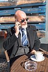 Bearded Businessman With Sunglasses Talking On Smartphone Stock Photo