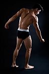 Beautiful And Muscular Man In Dark Background Stock Photo