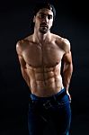 Beautiful And Muscular Man In Dark Background Stock Photo