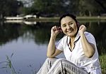 Beautiful Asian Woman Listening Music In Headphones Stock Photo