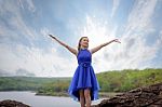 Beautiful Blue Dress With Her Arms Outstretched Enjoying On The Stock Photo