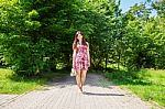 Beautiful Brunette Standing Barefoot On The Sidewalk Stock Photo