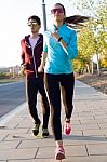 Beautiful Couple Running In The Street Stock Photo