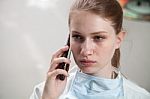 Beautiful Doctor Using A Smart Phone Stock Photo