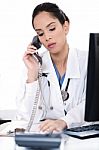 Beautiful Female Doctor Trying The Phone Very Seriously Stock Photo