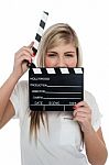 Beautiful Female With Clapperboard. It's Showtime Stock Photo