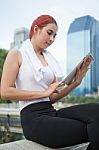 Beautiful Fitness Asian Woman With Tablet In Park City Stock Photo