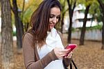 Beautiful Girl Chatting With Mobile Phone In Autumn Stock Photo