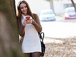 Beautiful Girl Chatting With Mobile Phone In Autumn Stock Photo